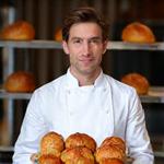 Marc, Head Pastry Chef, presenting a basket of freshly baked croissants