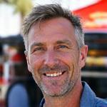 Marcus Thorne, Festival Director, overseeing a busy festival with a Daily Grind & Bean Co. mobile coffee stand.