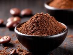 Raw cacao nibs and powder in small dishes.